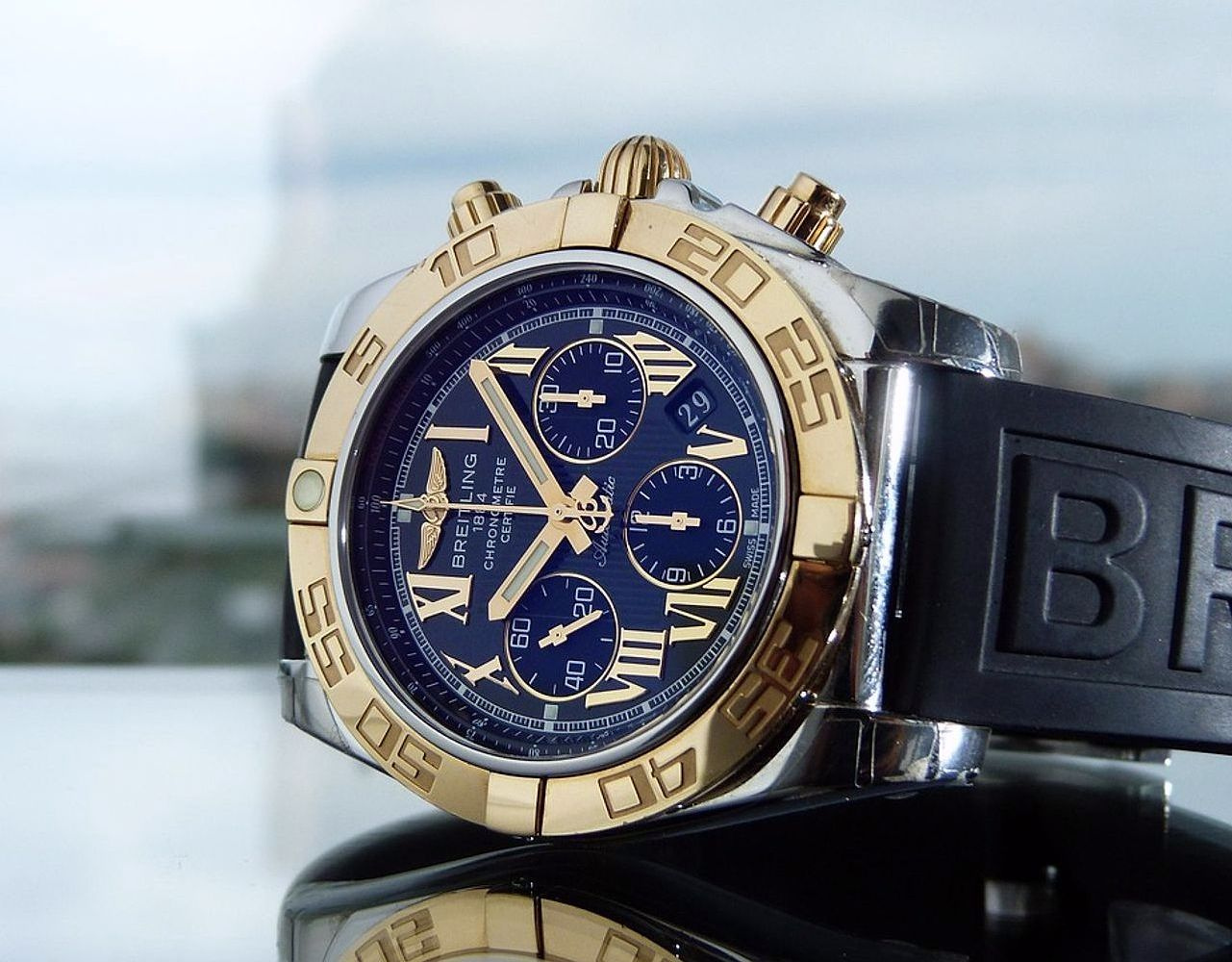 Master watchmaker examining gears under magnification