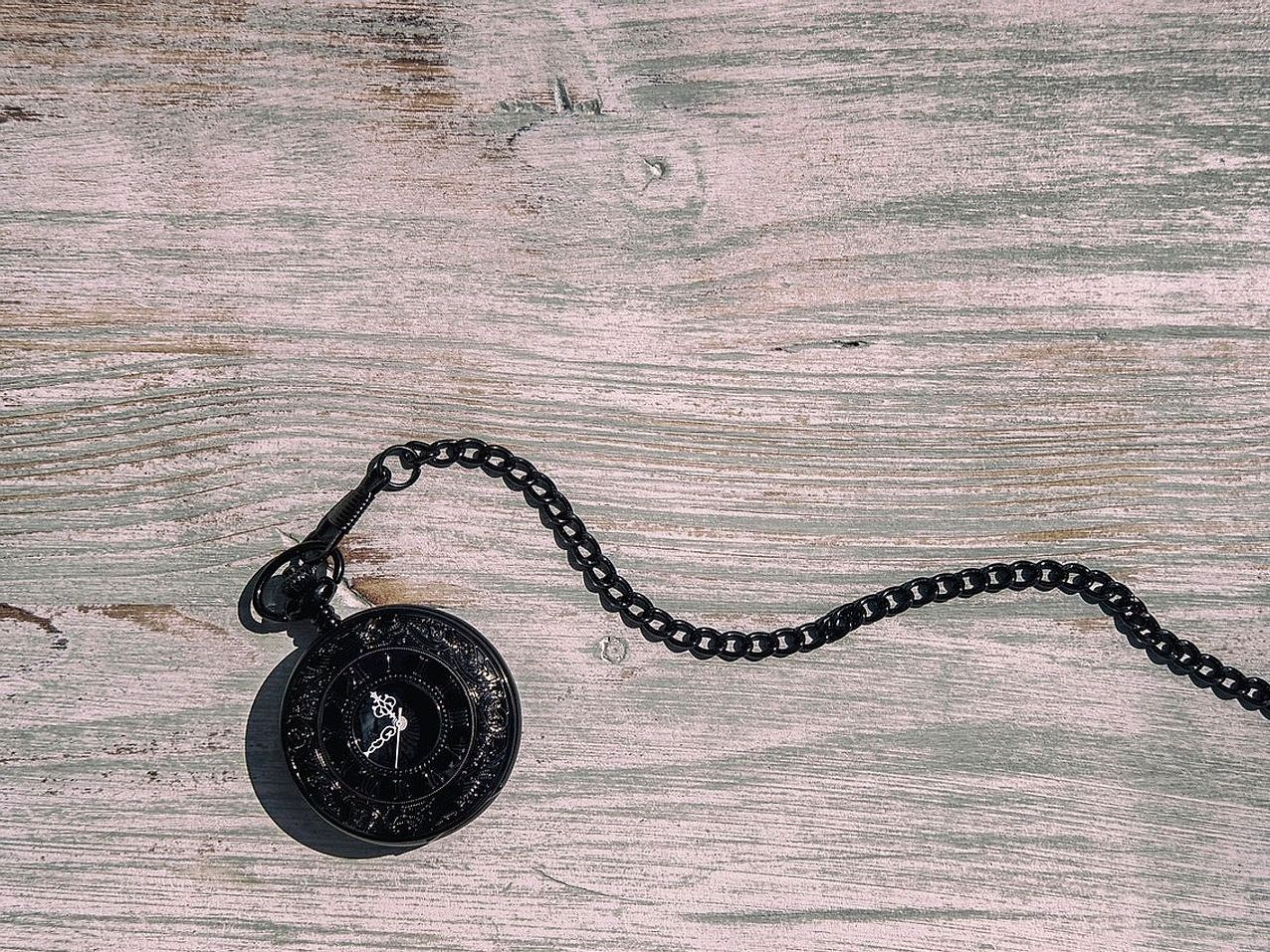 A worn workbench and jeweler's tools on a cloth